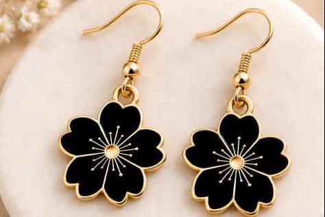 Black enamel flower earrings with gold accents, elegant women's fashion jewelry