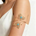 Gold butterfly arm cuff with turquoise stone, elegant women's fashion accessory