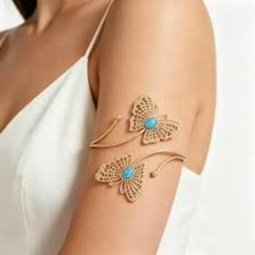 Gold butterfly arm cuff with turquoise stone, elegant women's fashion accessory