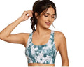 Woman wearing teal and white tie-dye sports bra, ideal for fitness and casual wear